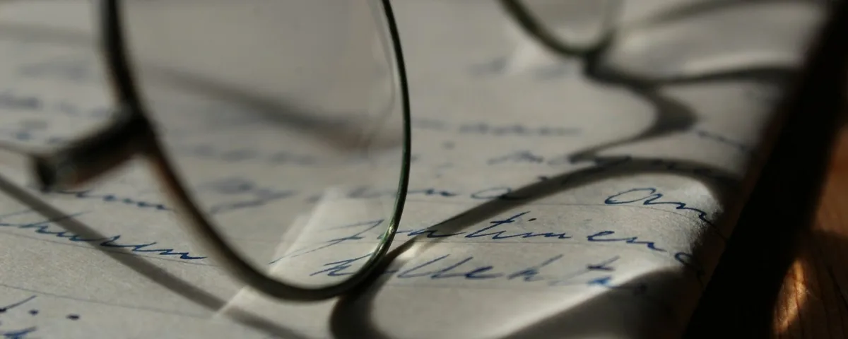 Reading glasses on a handwritten letter