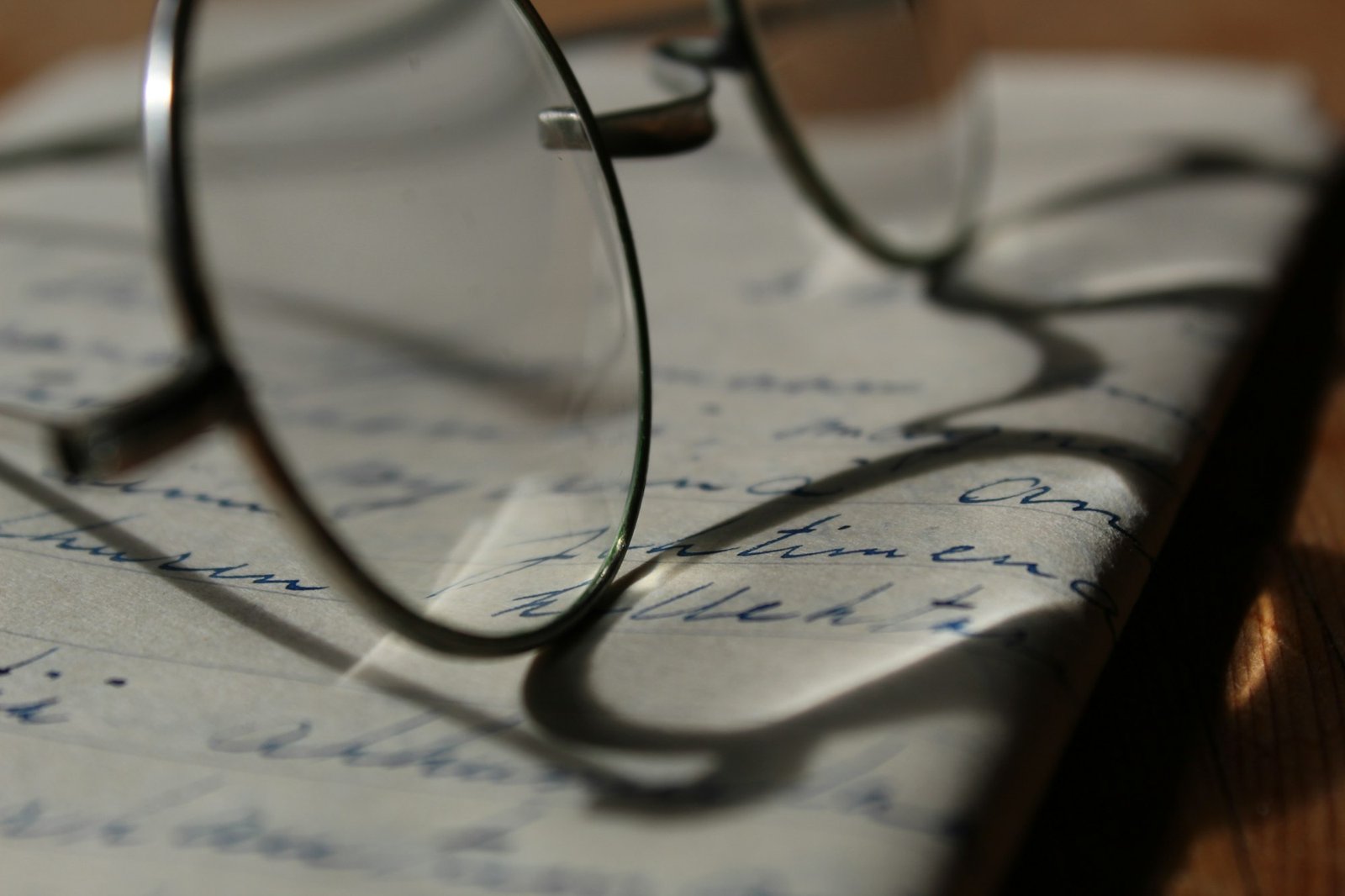 Reading glasses on a handwritten letter