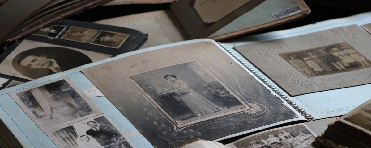 Old black-and-white family photographs spread on a table