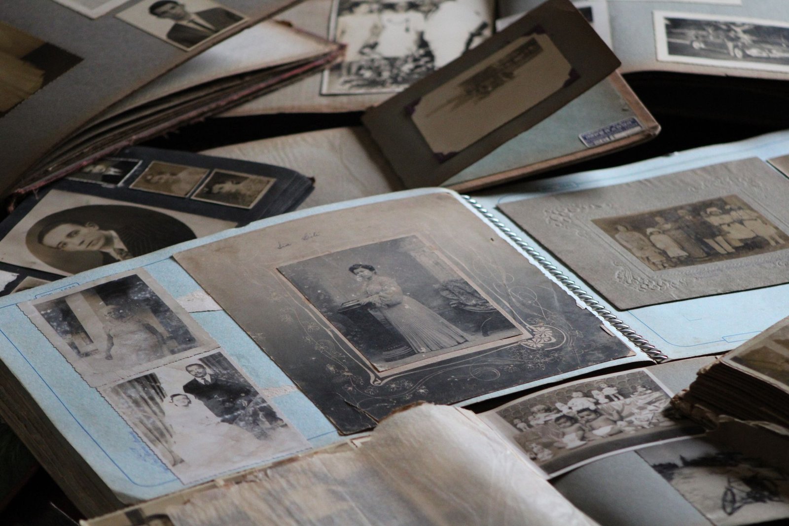 Old black-and-white family photographs spread on a table