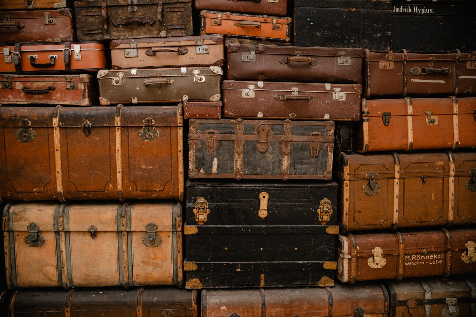 A stack of old leather and metal trunks